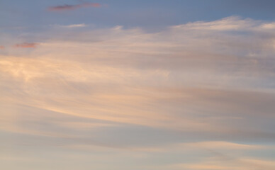 Obraz premium Delicate blurred shroud of clouds on a blue sky. Sunset.