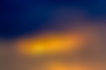 Blurred background. No sharpness. Dark blue, orange spots.