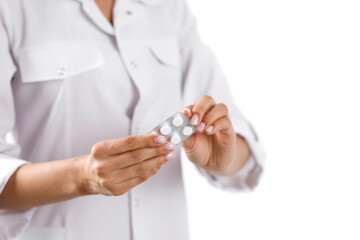 the doctor holds pills in his hand, close-up, white background