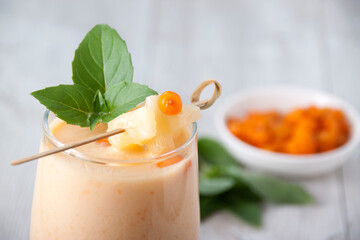 Sea buckthorn smoothie with canned pineapple and basil