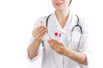 Girl doctor in a medical white coat holding a flask in his hands with blood samples close-up. Laboratory work in the hospital