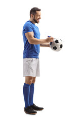 Athlete signing his autograph on a soccer ball