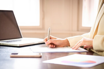 Shot of businesswoman's hand while fill the form