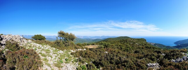 Panaroma of greek landscape on mountain with path and blue sky