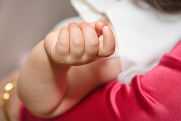 Little baby hand. The baby is in the arms of the mother.