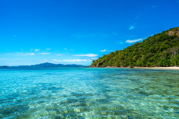 Coron, Philippines - January 3, 2020: People relaxing on Malcapuya Island, Coron, Philippines.