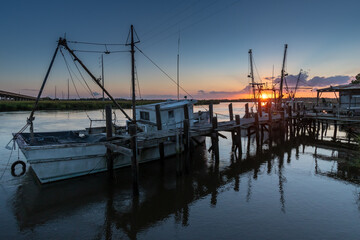 The sun setting on the shrimp boat docks along the Darien River at the port town of Darien