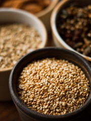 Traditional whole foods, grains, nuts and seeds in rustic, natural light setting with custom made cermics.