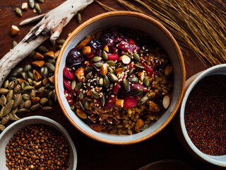 Traditional whole foods, grains, nuts and seeds in rustic, natural light setting with custom made cermics.