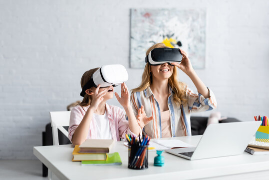 Selective Focus Of Smiling Mother And Kid Using Vr Headsets During Online Education At Home