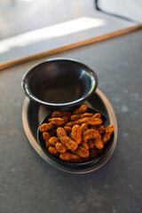 Boiled peanuts. Pistachios. Almonds. Walnuts. Cashews. Pecans. Roasted and lightly salted variety of different shelled nuts, used for ingredients in menu items at restaurants. 