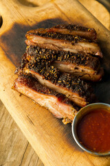 Barbecue catering platter with variety of meats. Traditional Texas BBQ: Beef brisket, beef ribs, pork ribs, sausage links, black pepper roasted chicken, and turkey served with homemade sauce.