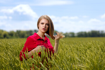 Portrait of young girl on a rye field. Shallow focus.