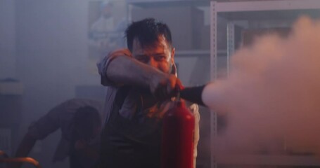 Workers trying to extinguish fire in warehouse