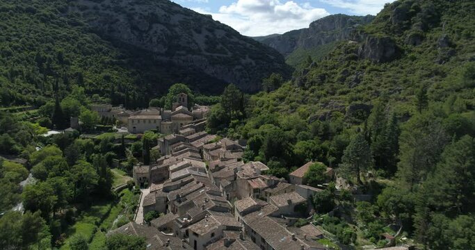Saint-Guilhem-le-Désert aerial frontal travelling, Hérault, labelled Les Plus Beaux Villages de France