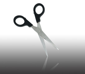 scissors with black handle and mirror reflection on a white background in isolation