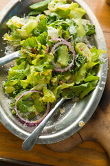 Garden salad. Classic American salad with iceberg lettuce, blue cheese dressing, red onions, bacon lardons, Parmesan cheese, olive oil, lemon juice, salt and pepper. A Fine dining restaurant classic.
