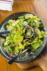 Garden salad. Classic American salad with iceberg lettuce, blue cheese dressing, red onions, bacon lardons, Parmesan cheese, olive oil, lemon juice, salt and pepper. A Fine dining restaurant classic.