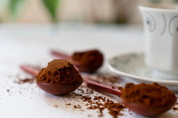 Ground coffee bean in wooden spoon and Turkish coffee