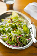 Salad. Classic American or French restaurant salad made w/ kale, Arugula, almonds, blueberries, walnuts, tomatoes, bacon, blue cheese, avocado, tossed w/ olive oil.