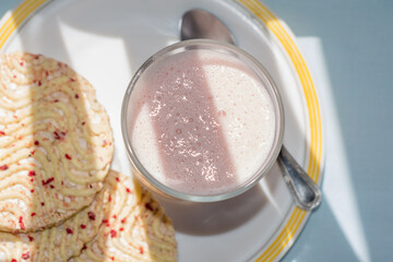 Glass of strawberry smoothie and cookies
