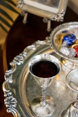 Fototapeta na wymiar Sherry in silver cup with chocolate before retiring. Gourmet photo for art decoration and blog story.