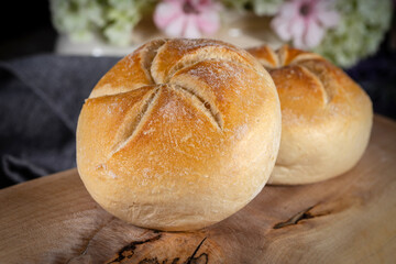 Kaiser buns on cutting board.