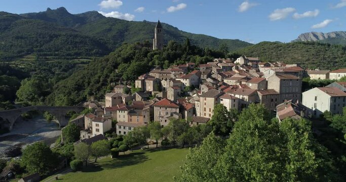 Olargues appearing behind trees, H&eacute;rault, labelled Les Plus Beaux Villages de France