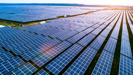 Photovoltaic solar panels at sunrise and sunset.