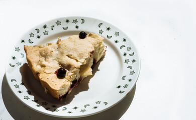 slice of homemade berry pie in a white plate with green pattern. Homemade sweets, homemade pie, cake and pastries 