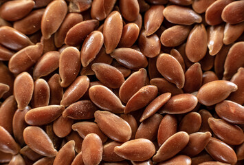 Fullscreen macro closeup with shallow depth of field of flax seed. Texture. Graphic design.
