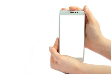 Female hand holding a big white smartphone with a white screen and a blank space for an inscription on an isolated white background
