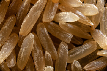 Macro closeup of brown rice unfolded across the screen. Brown rice texture. Food. Graphic design.