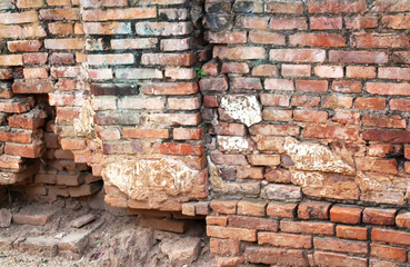 17 Old orange brick wall with breaks in a Buddhist temple