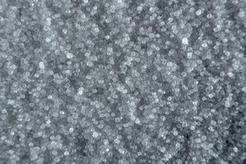Fullscreen macro closeup with shallow depth of field of small grains of fine salt. Texture. Graphic...