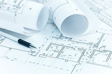 architectural project plans, blueprint rolls, pencil and ruler. architect workplace background.