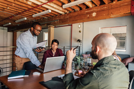Men Work Together in a Modern Office