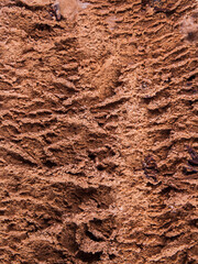 Chocolate ice cream tub texture background, macro shot. Vertical