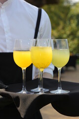 Catering. Lemonade in glass on a tray. Summer, Sunny day. Banquet. Soft drink. Background image, copy space