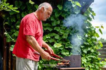 Fototapeta premium A man preparing grilled food