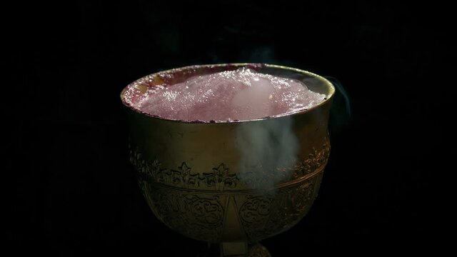 Man Takes Goblet Of Bubbling Potion