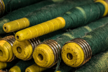 spools of thread on a wooden background