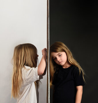 Child Sad Against Wall