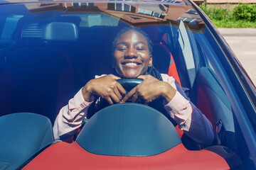 Happy African American in the car