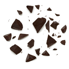 Cracked chocolates / broken chocolate chips or chocolate parts top view isolated on white background