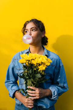 Woman With Flowers Doing Ballon With Gum