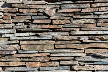 Fototapeta premium The stone wall texture background natural color.Background of stone wall texture photo.Natural stone wall texture for background.Old Brick texture, Grunge brick wall background.