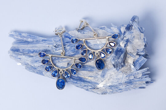 Jewelry earrings with kyanite or distin mineral from Brazil. Blue aluminosilicate mineral with columnar crystals and metamorphic rock. Called two forces.