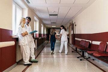 Conversation between doctor and nurses in hallway