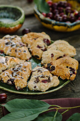 Cranberry & Cherry Scones. Baking on an old wooden table in rustic style.